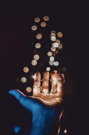 An upward facing palm covered in fairy lights: NemoOmnibus_Poems_Her